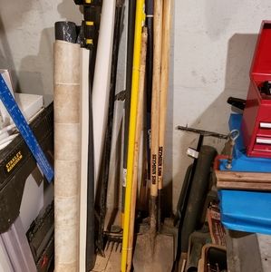 Several shovels and a post digger.